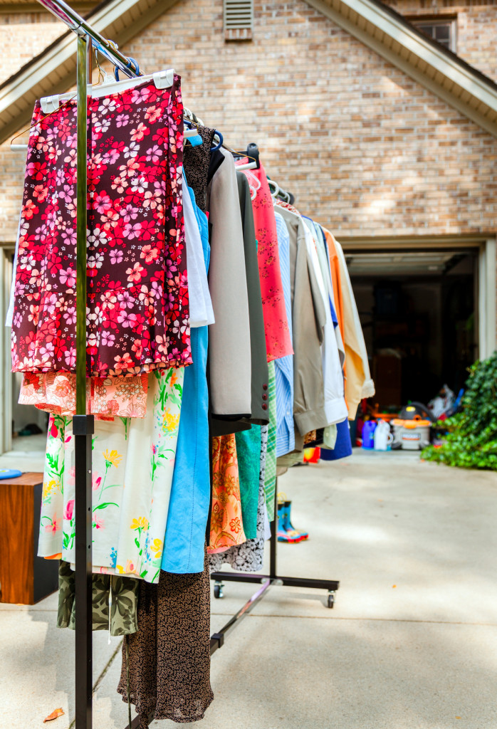 Image of clothes on hangers at a garage sale