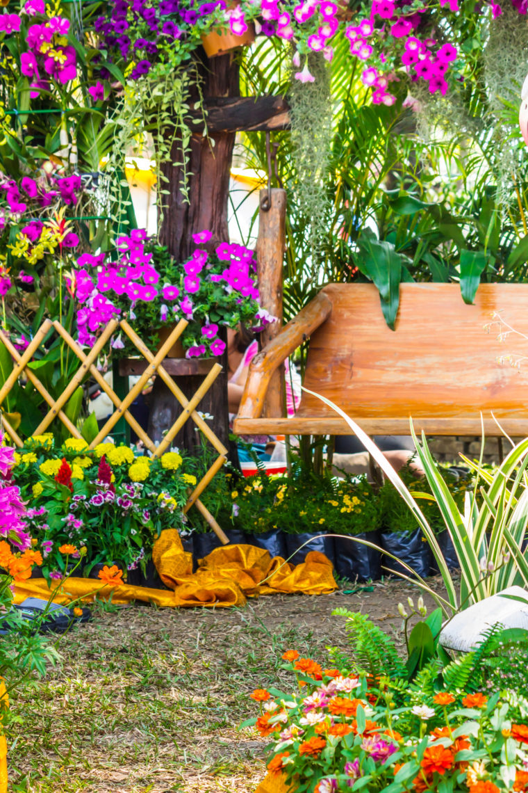 Wood chair in the flowers garden./ Wood chair in the flowers garden on summer.