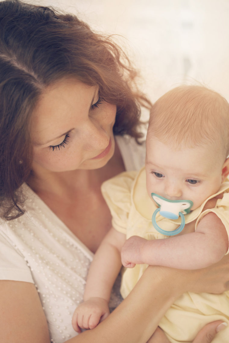 Mother holding adorable baby girl