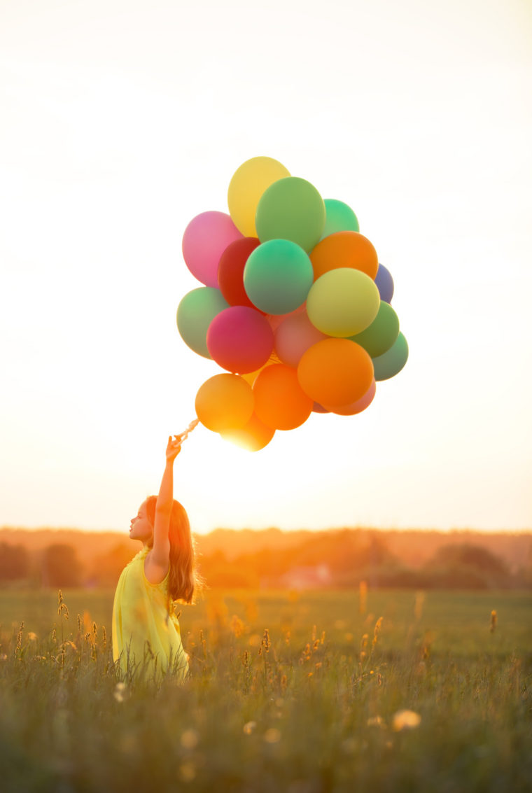 Beautiful girl with balloons outdoors